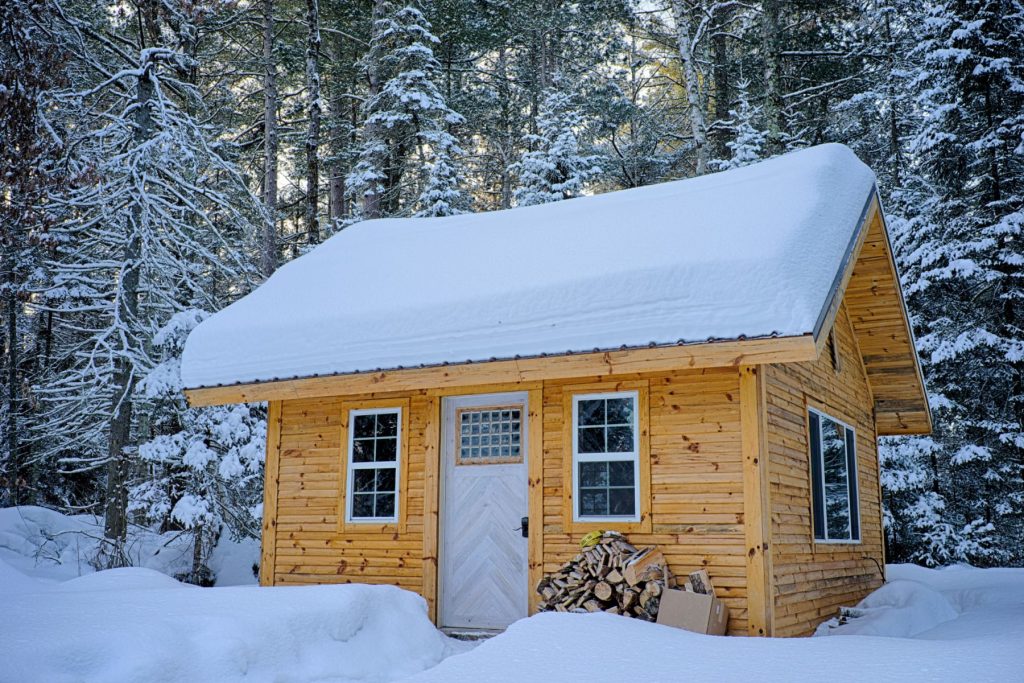 cabin with snow on roof